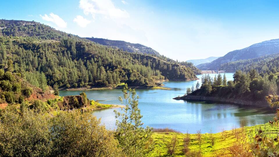 A lake surrounded by forested hills.