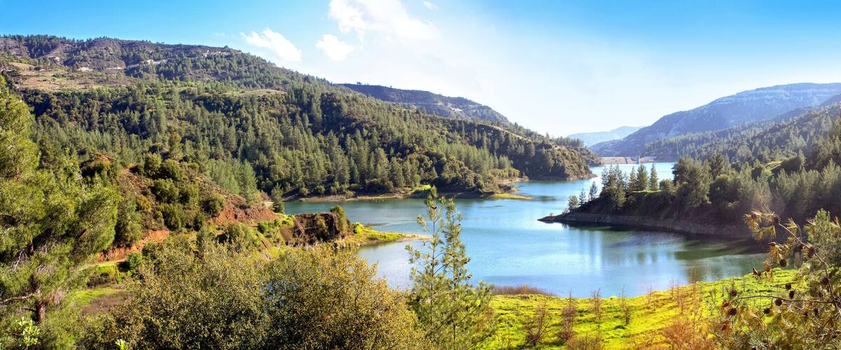 A lake surrounded by forested hills.