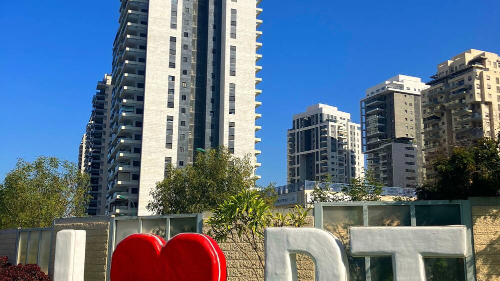 Petah Tikva is a city in Israel. The symbol of the city against the backdrop of a new residential area. I love Petah Tikva