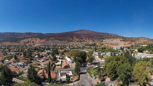 Kiryat Shmona, aerial view of the city skyline surrounded by mountains.