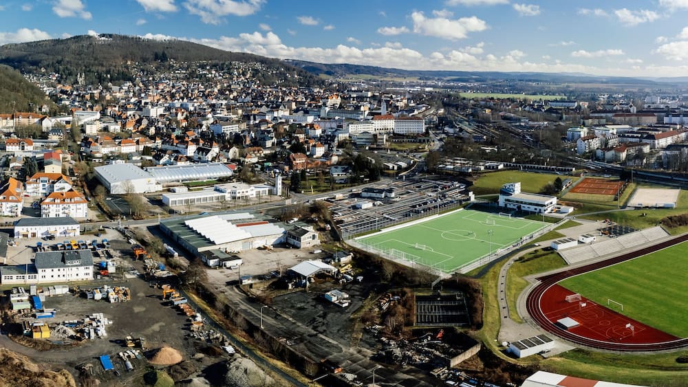 Drone shot of a football stadium and buildings in the city of Sonneberg in Thuringia, Germany