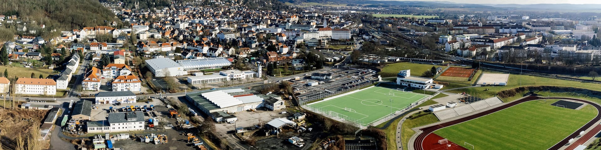 Drone shot of a football stadium and buildings in the city of Sonneberg in Thuringia, Germany