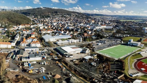 Drone shot of a football stadium and buildings in the city of Sonneberg in Thuringia, Germany