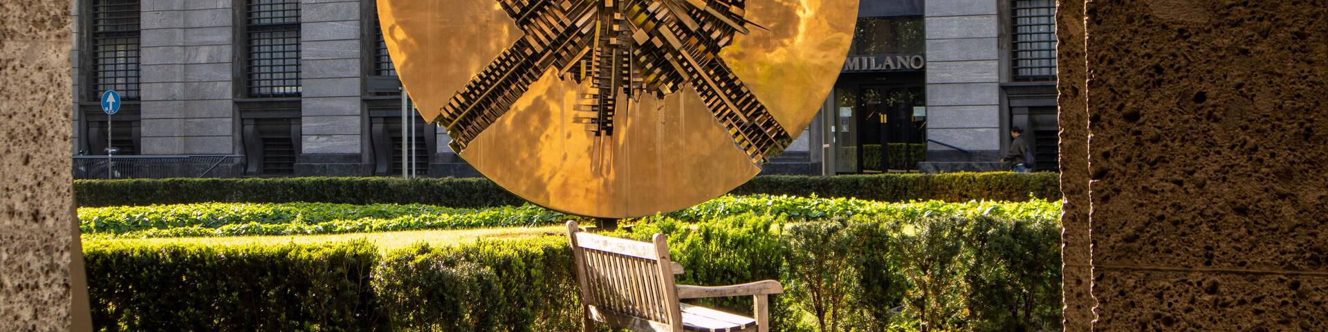 the solar disk inspired by the Aztec calendar by Arnaldo Pomodoro in the Meda square flowerbed. Milan, Lombardy, Italy