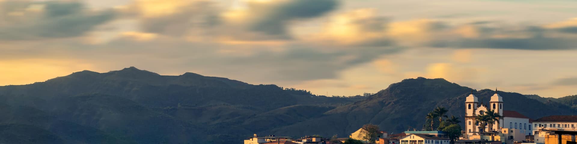 Panoramic view from Congonhas, MG, Brasil. Church and moutains with a lot of clouds as background