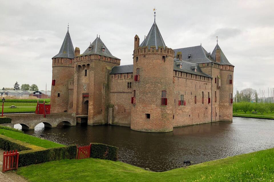 A historic castle with multiple towers and a moat.