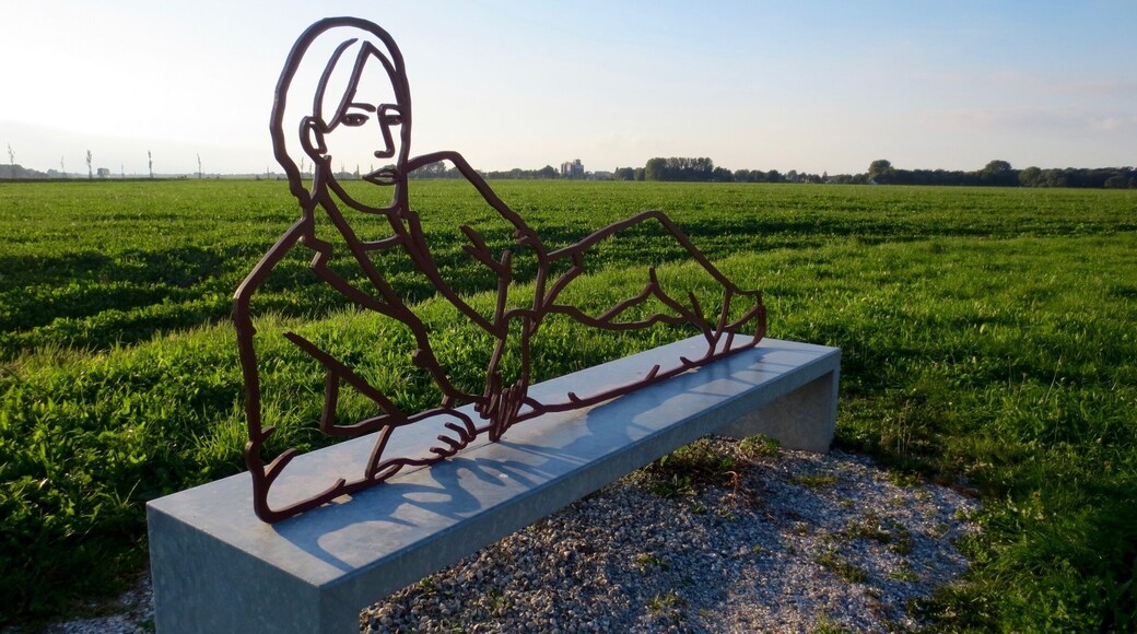 Rustpunt tussen Uithuizen en Oldenzijl.
RUSTPUNTEN – RECLINING SCULPTURES EEMSMOND
The art project Rustpunten (resting points) consists of a network of sculptures that are placed along cycling routes in the Netherlands. In beautiful places along these paths large figurative sculptures seem to have settled on a long bench. They rest or sleep in the peace and tranquility of the flat Dutch landscape. The more than life-size figurative sculptures depict contemporary people. Cut out of thick, solid steel, the figures seem to be drawn in the open space of the landscape.
http://www.staatineemsdelta.nl/project/47/rustpunten