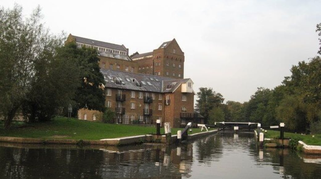Coxes Mill, River Wey Navigation Coxes Mill is 1.5miles south of the Thames near Weighbridge. In 1776 an ironmaster recognised the potential the site offered and started to build his iron mill which became known as Coxes Lock Mill. It is generally regarded as industrially the most significant mill on the Wey, its importance reflected perhaps by the fact that it was not to finally close until 1983, making it the last commercially operated mill on the Wey Navigation. The mill was rebuilt in 1901 and extended in 1906, becoming one of the most important industrial buildings in the country at the time. The three mill buildings, having been listed for preservation under a Grade II category, were converted to residential use after its closure in 1983. (http://www.weyriver.co.uk/theriver/wey_nav_8.htm)