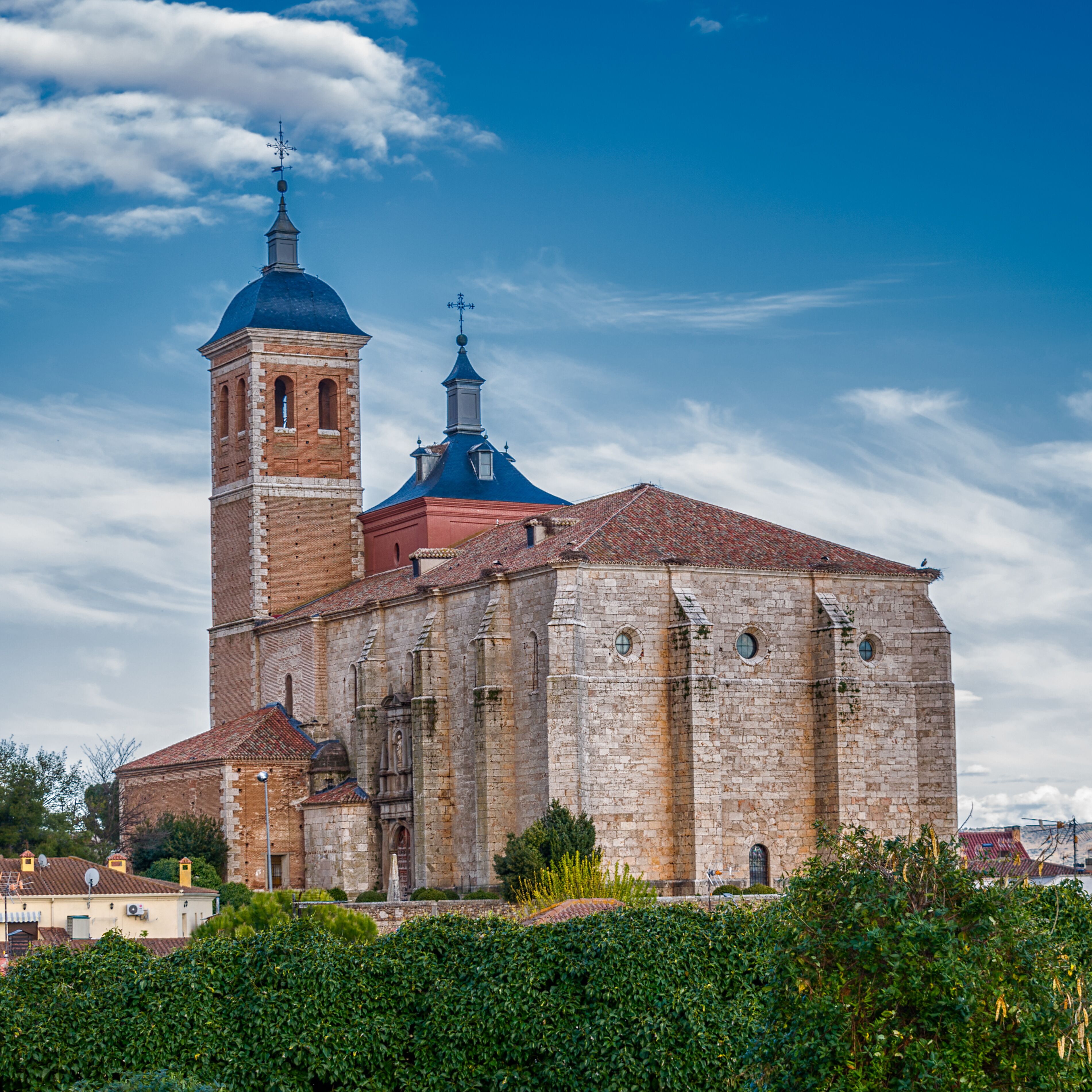 A historic church with a prominent bell tower and a blue dome.