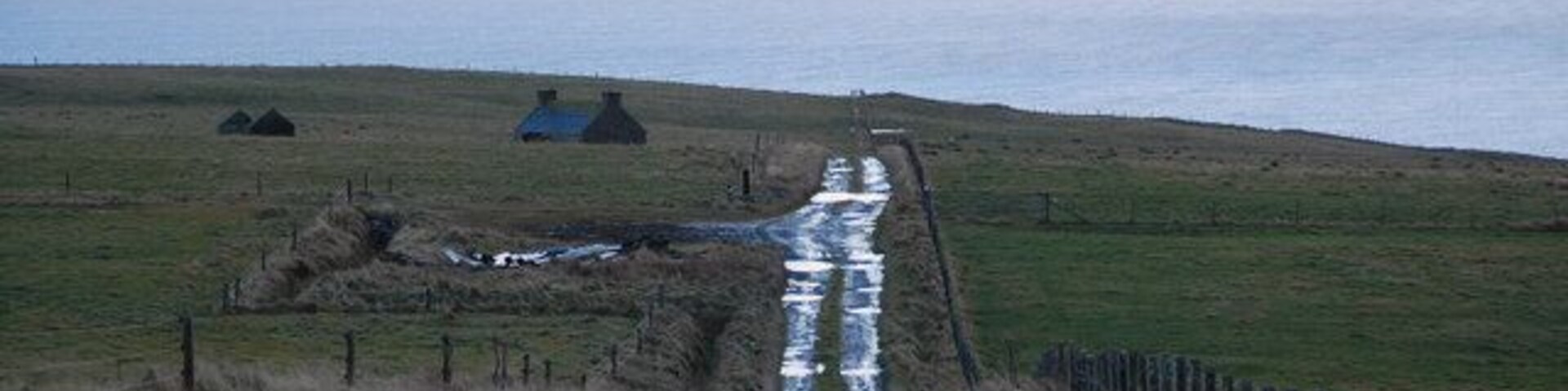 Rough track, rough grazing, derelict crofthouse At the bottom of Ward Hill, looking southeast along the rough track. Just after the photo was taken, a shower of sleet reduced visibility to a few metres.