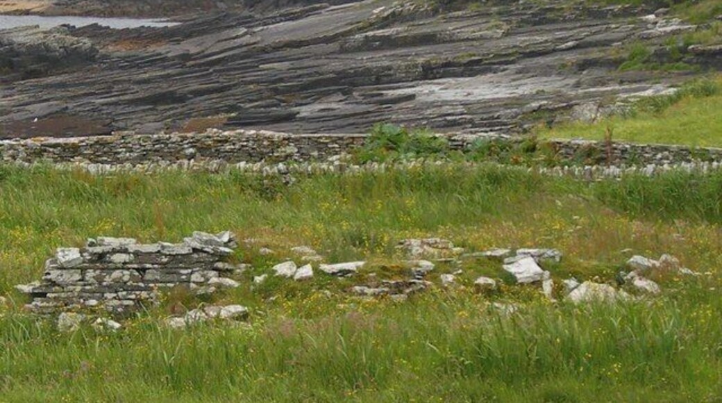 Ruined chapel and rock beach, Shapinsay The chapel ruins are difficult to see due to the one metre high rough grass. The drystone wall at the centre is in good repair. The rock sheeted beach adjoins Linton Bay.