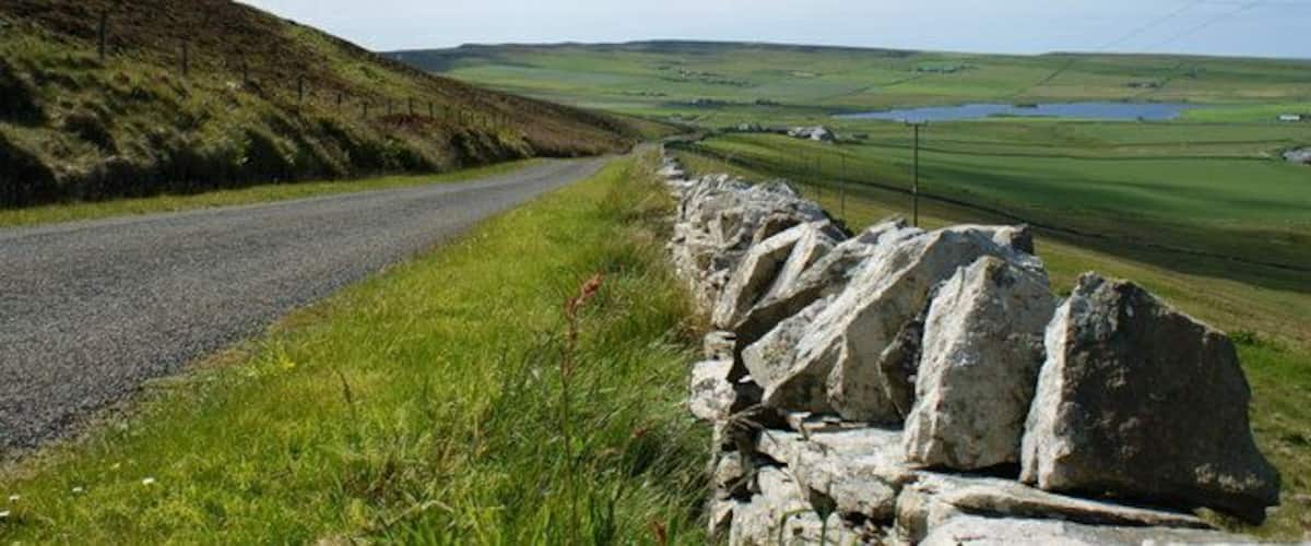 B9064 road heading towards Loch of Wasbister The B9064 forms part of the road around the coast of Rousay