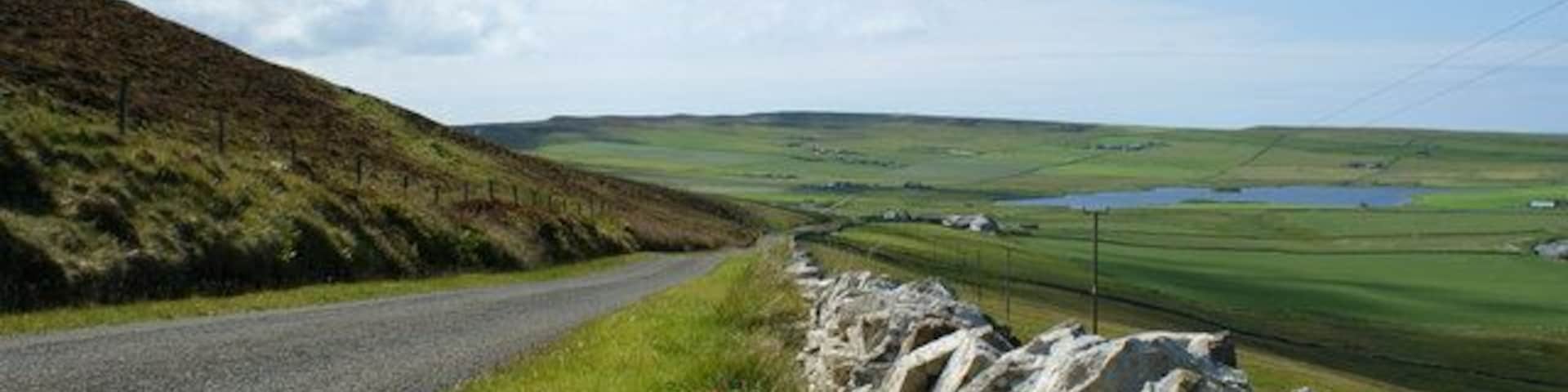 B9064 road heading towards Loch of Wasbister The B9064 forms part of the road around the coast of Rousay