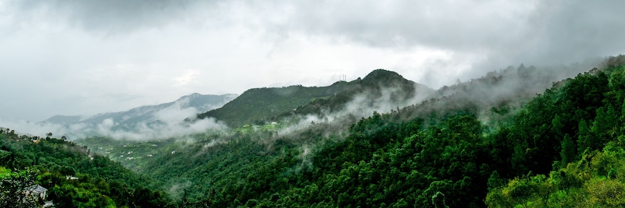 clouds floating over the mountain range as seen while driving to Binsar, near Almora, Uttarakhand,. rainy season, monsoon India