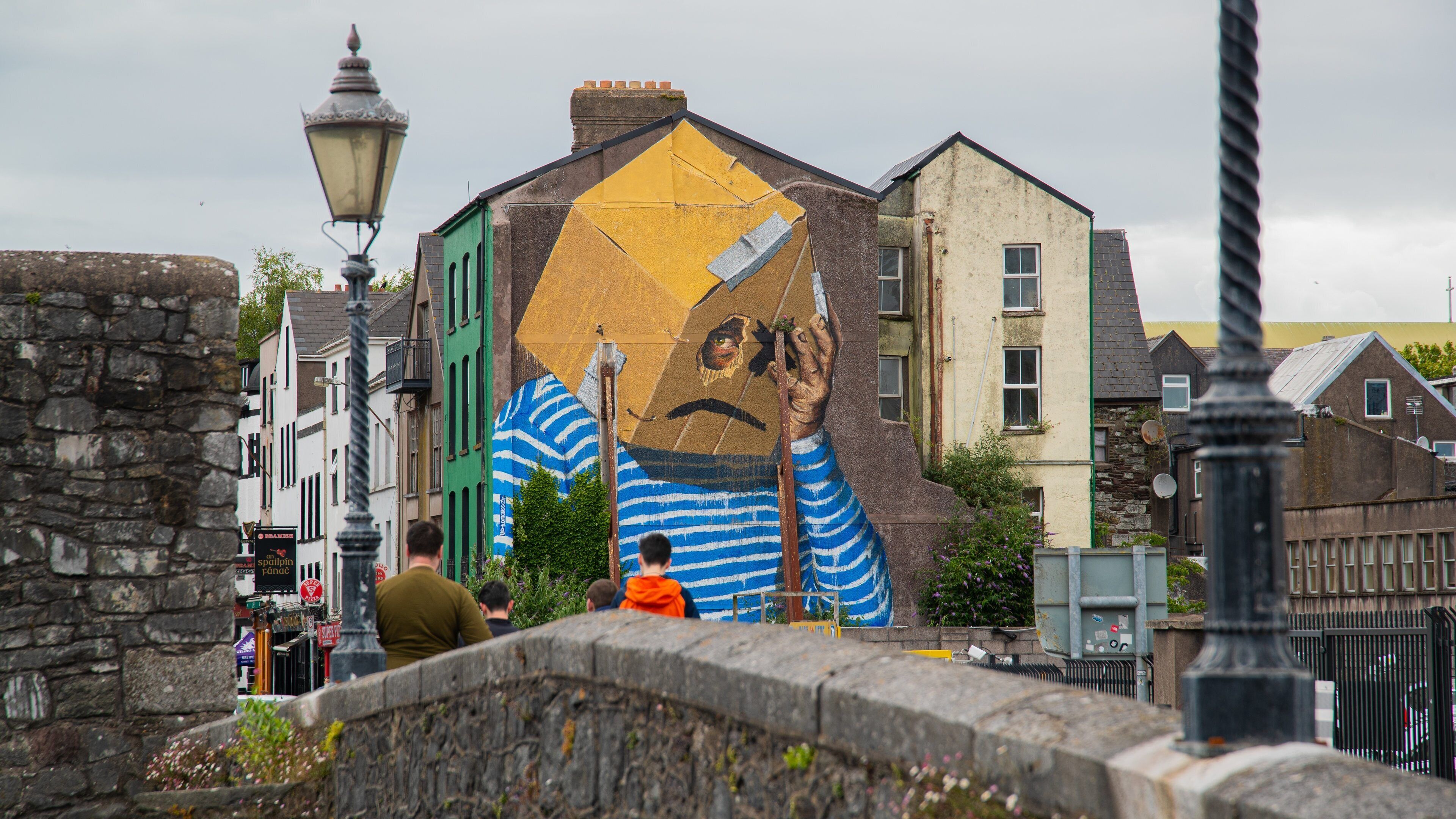 Cork City Centre featuring a bridge and outdoor art as well as a family