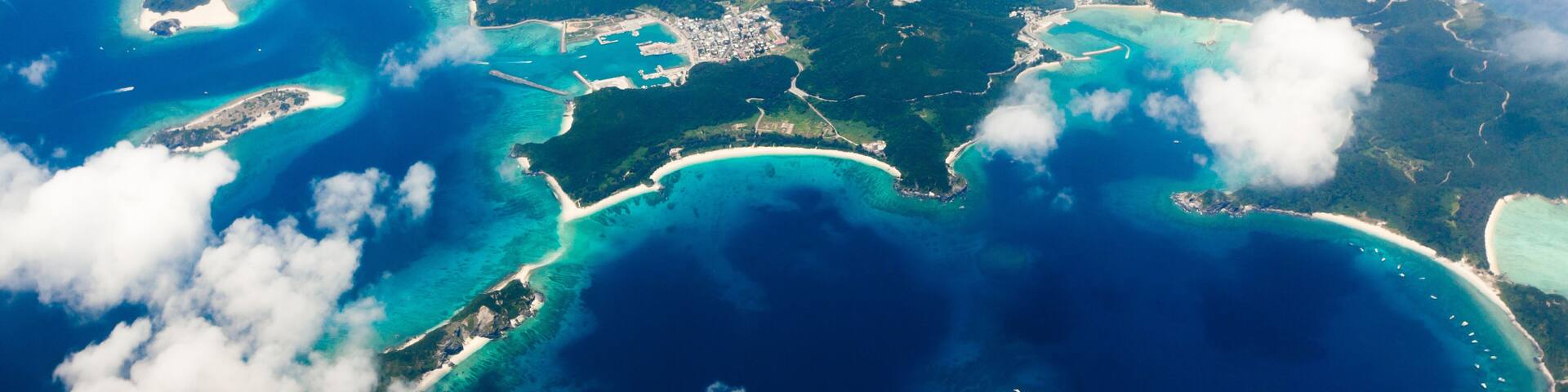 Aerial view of the Japanese tropical islands surrounded by coral reefs with clear blue water, Kerama Islands, Okinawa, Japan