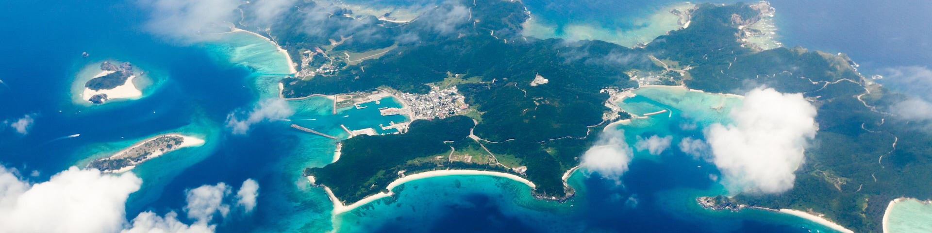 Aerial view of the Japanese tropical islands surrounded by coral reefs with clear blue water, Kerama Islands, Okinawa, Japan