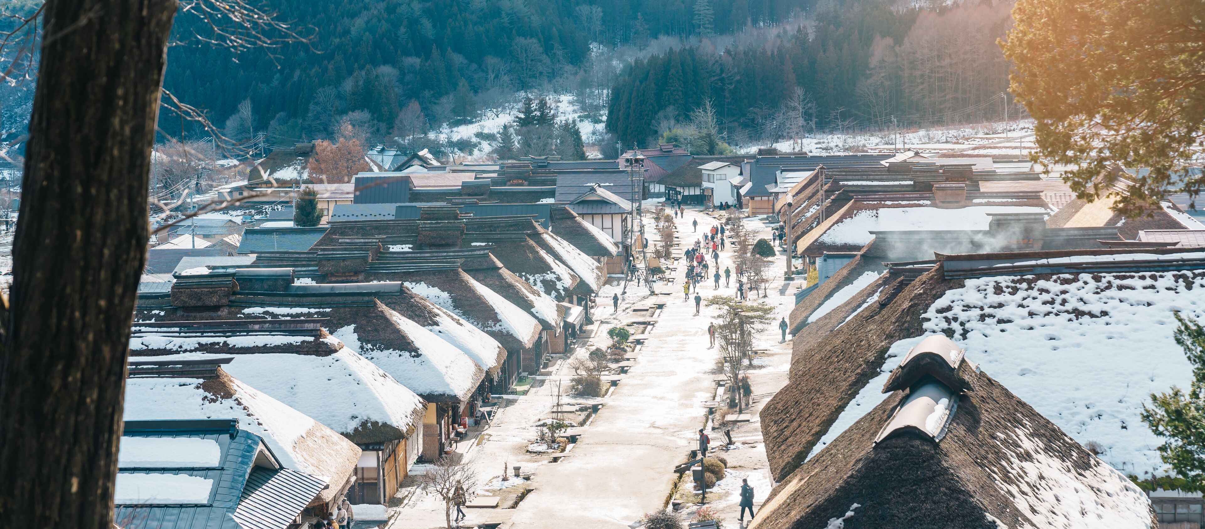 A snow-covered village with traditional houses and a central path.