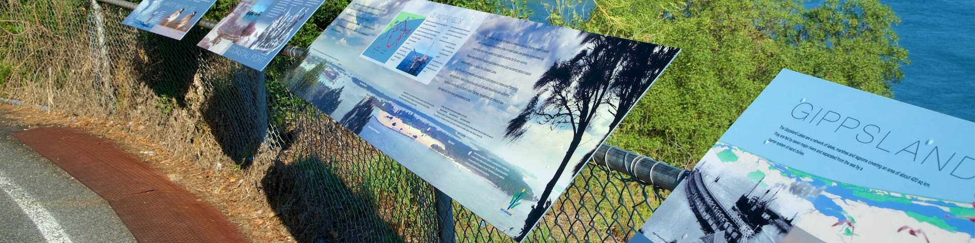 A coastal viewpoint with informational signs and a view of the sea.