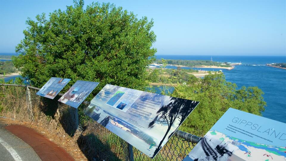 A coastal viewpoint with informational signs and a view of the sea.
