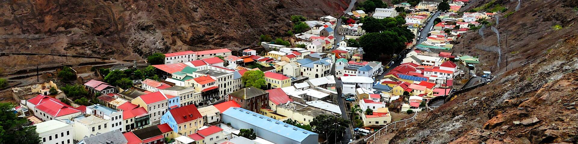 Jamestown, Saint Helena - Nestled between towering valley walls. This stunning image showcases the unique landscape and vibrant architecture of this remote island.
