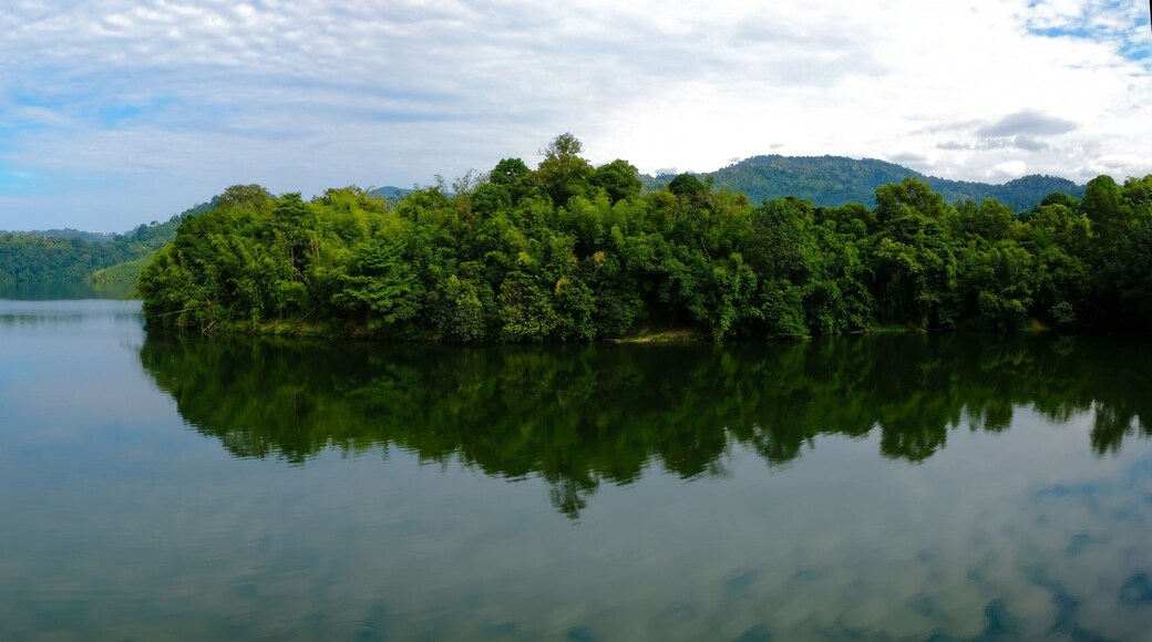 Panoramic shot of dam water surrounded with green trees in Kuala Kubu Bharu, Selangor, Malaysia.