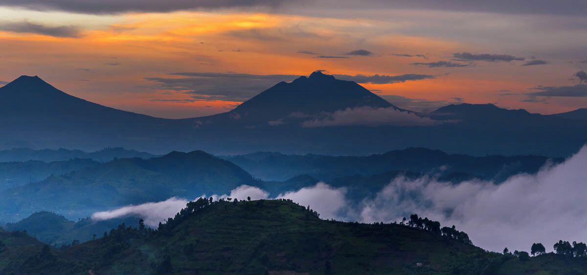 A mountain range with a prominent peak and surrounding hills.