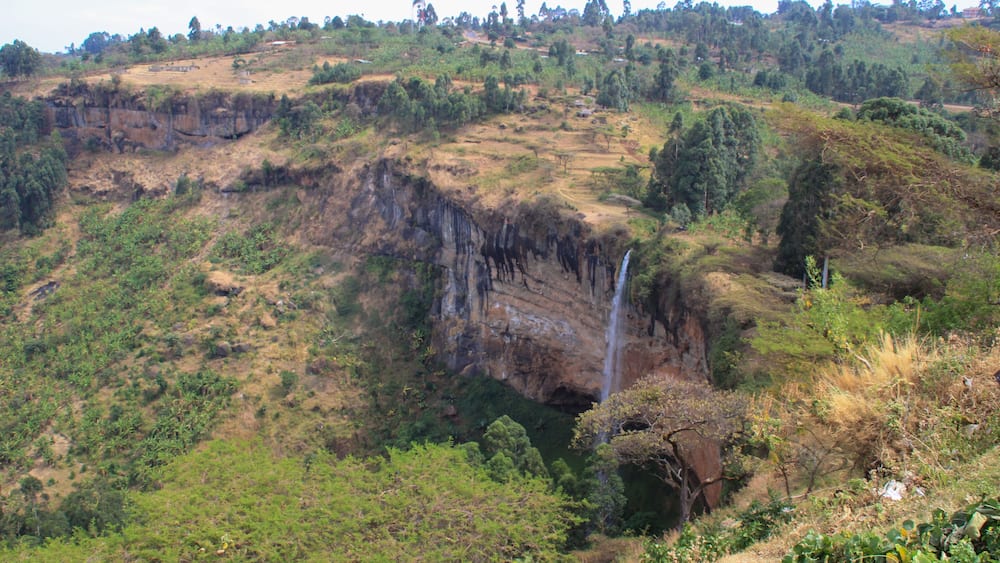 Tall and thin Sipi Falls flowing among rocks in Uganda