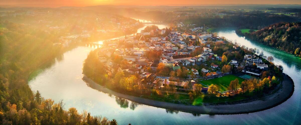 A river winding through a town surrounded by hills.