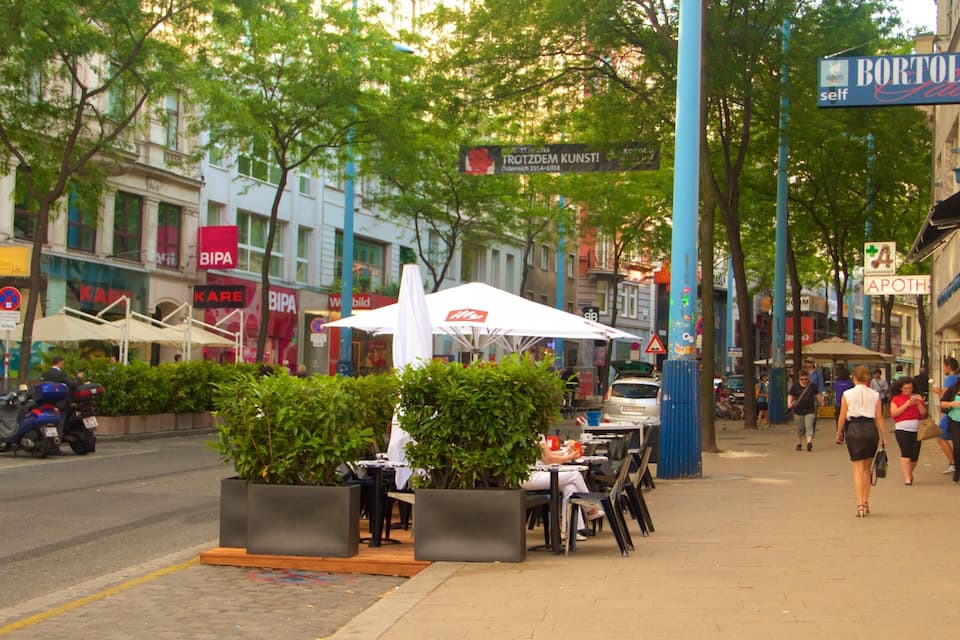 A street lined with cafes, a pharmacy, and a sign for Bortolootti.