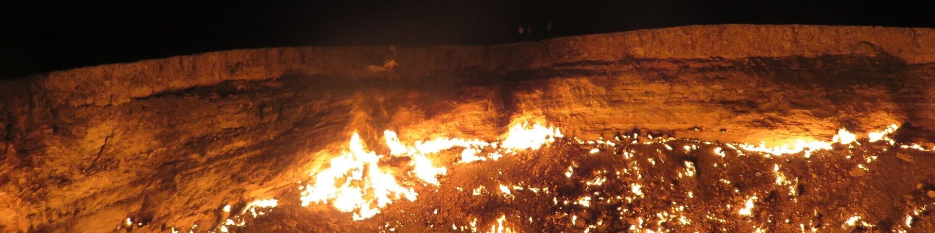 Alternatively called Derweze or the door to hell, this crater can be found in the Karakum desert of Turkmenistan, north of Ashgabat. While drilling in 1971, the Soviets tapped into this cavern filled with natural gas. They lit it thinking it would burn itself out in a matter of days. Not so, as you can see! It was mighty hot around the crater's edge, especially when there was a gust of wind. Can you see the people standing near the edge at the back in the middle? That will give you an idea of the size.