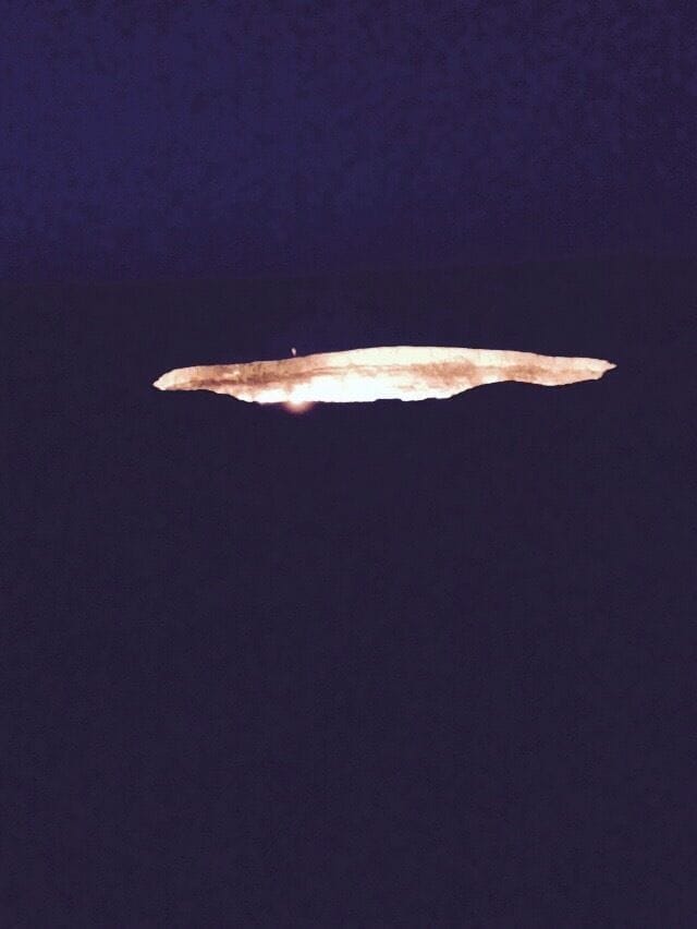 The gas crater was lit on fire by the Russians in the 60s. They thought it would burn itself out after a few days. Driving over sand dunes in the desert in the dark to arrive at the "Doors to Hell" is unique. By the way, the one little bright speck along the far side of the crater rim is a fellow traveller standing very close to the edge.