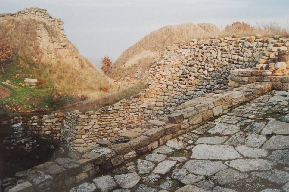 An ancient stone wall with a pathway.
