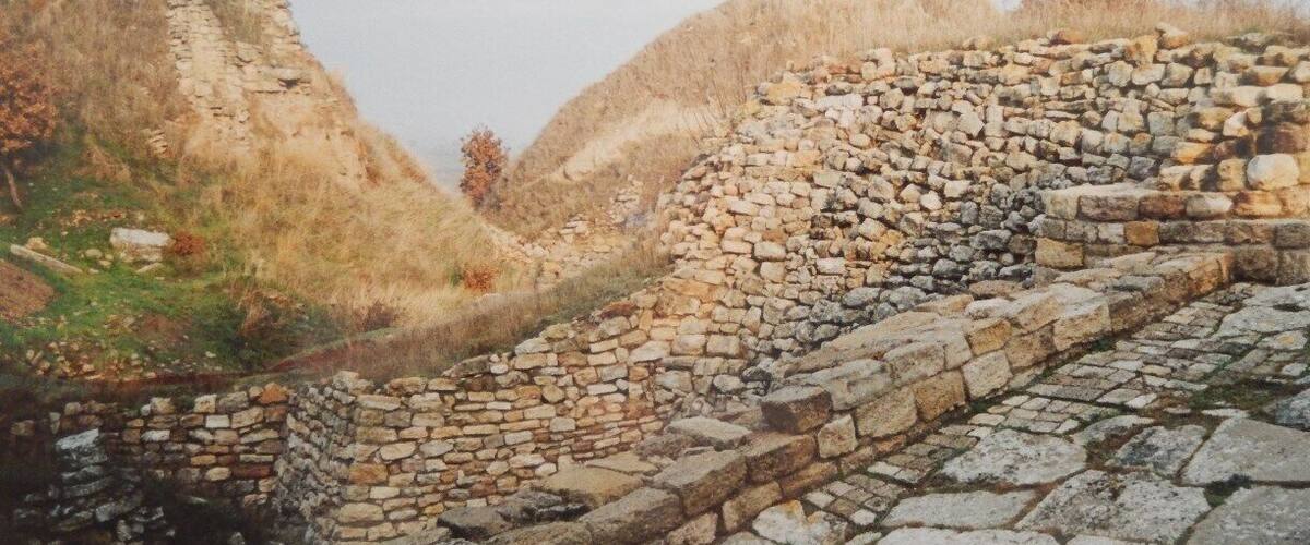 An ancient stone wall with a pathway.