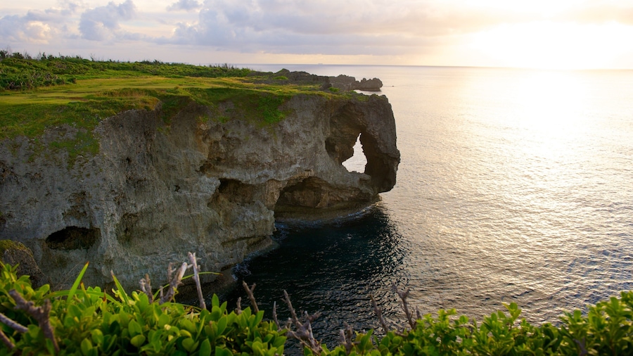 Cape Manza which includes a sunset and rocky coastline
