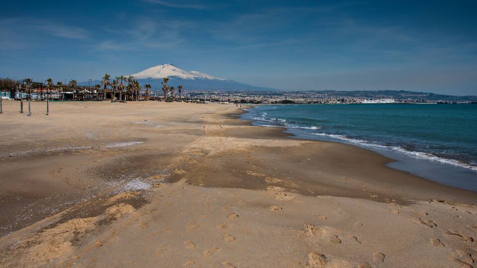Panoramic view of Mt. Etna with snow from the beach of Catania; Shutterstock ID 783312544