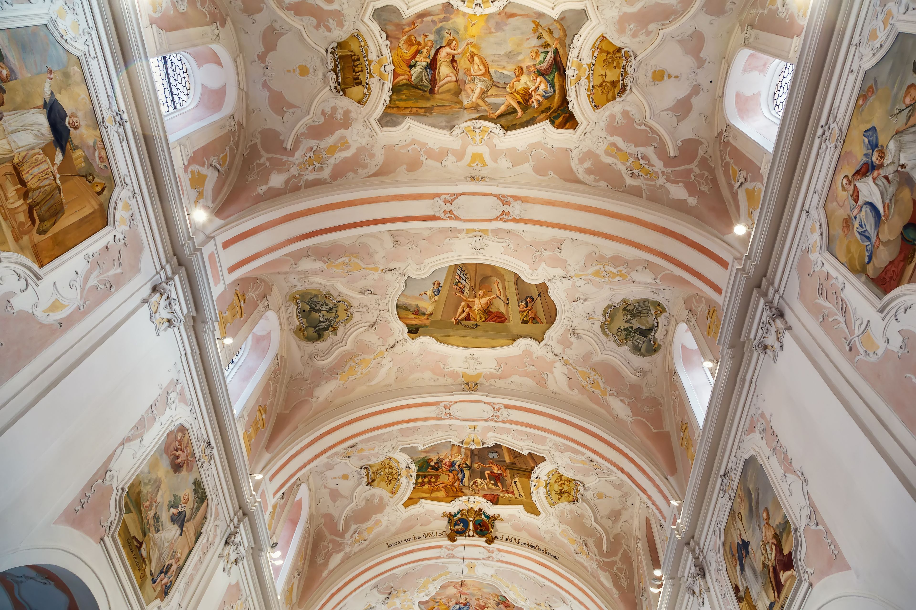 A grand, ornately decorated ceiling with frescoes and gold accents.