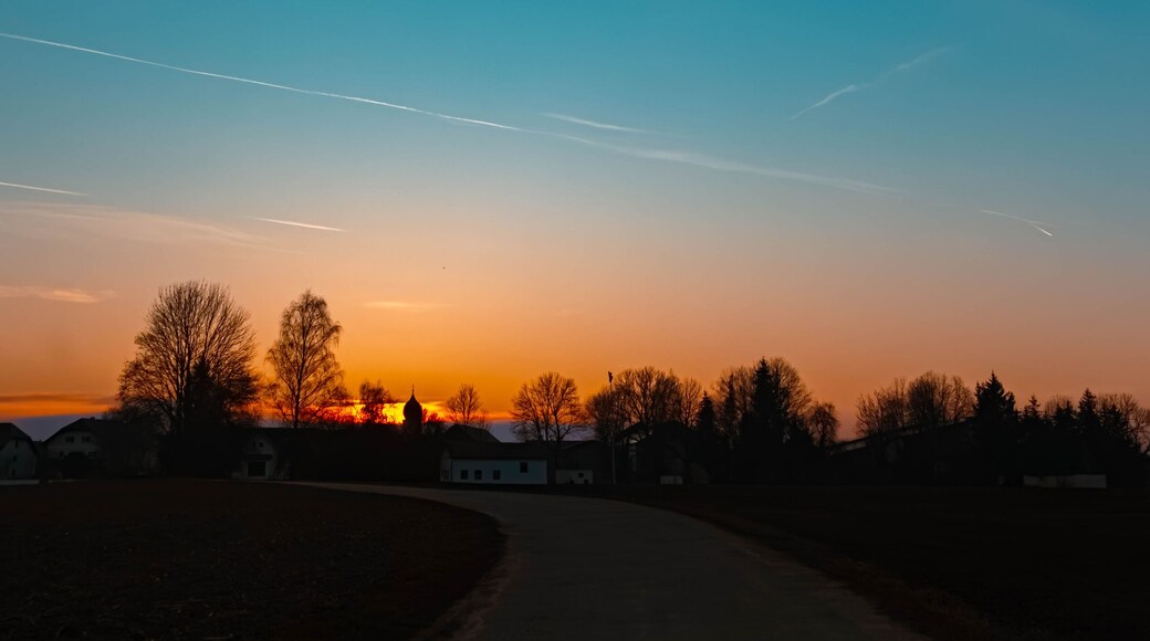 Spring sunset or sundowner with a church silhouette seen from near Arbing, Osterhofen, Deggendorf, Bavaria, Germany