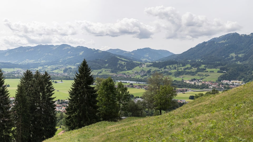 A mountainous landscape with a village nestled in the valley.