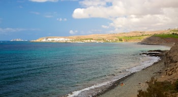 Meloneras Strand som viser en stenstrand og udsigt over kystområde