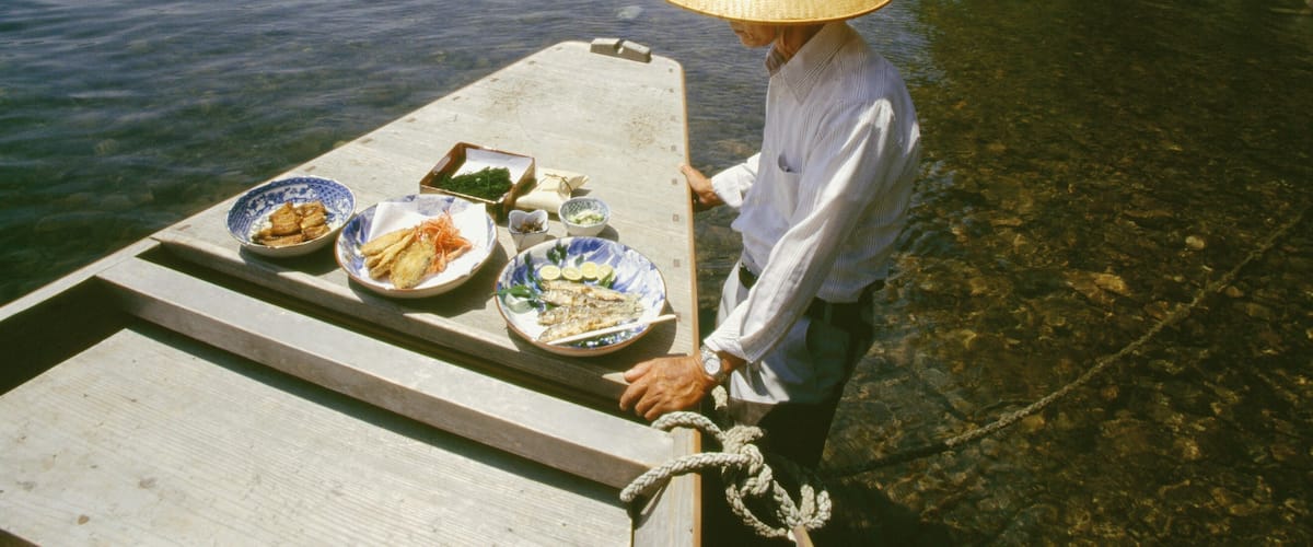 Mature man standing near a boat, Shimanto River, Kochi, Shikoku, Japan