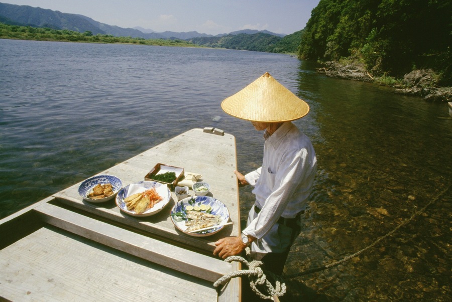 Mature man standing near a boat, Shimanto River, Kochi, Shikoku, Japan