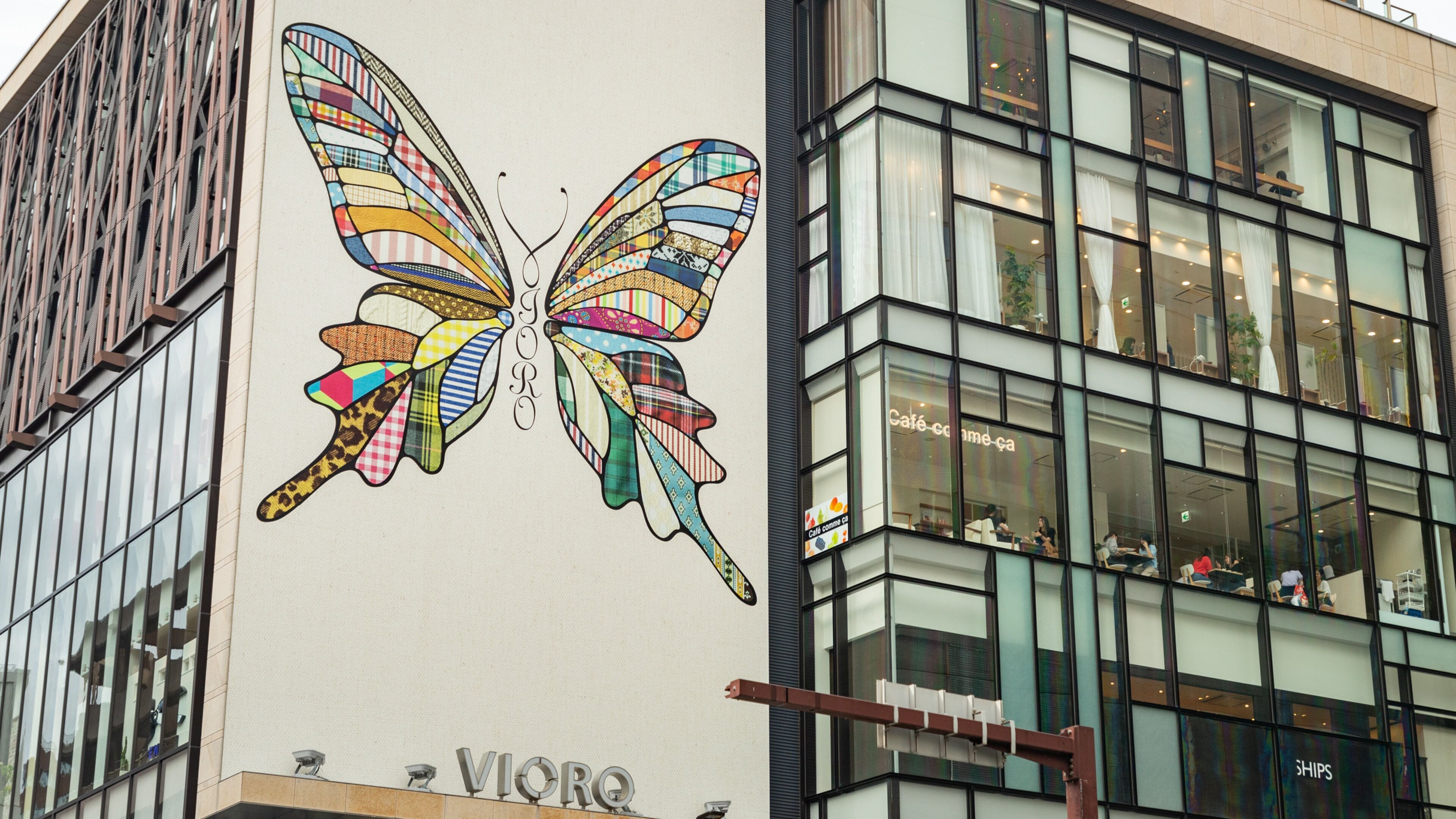 A building with a colorful butterfly mural on its side.