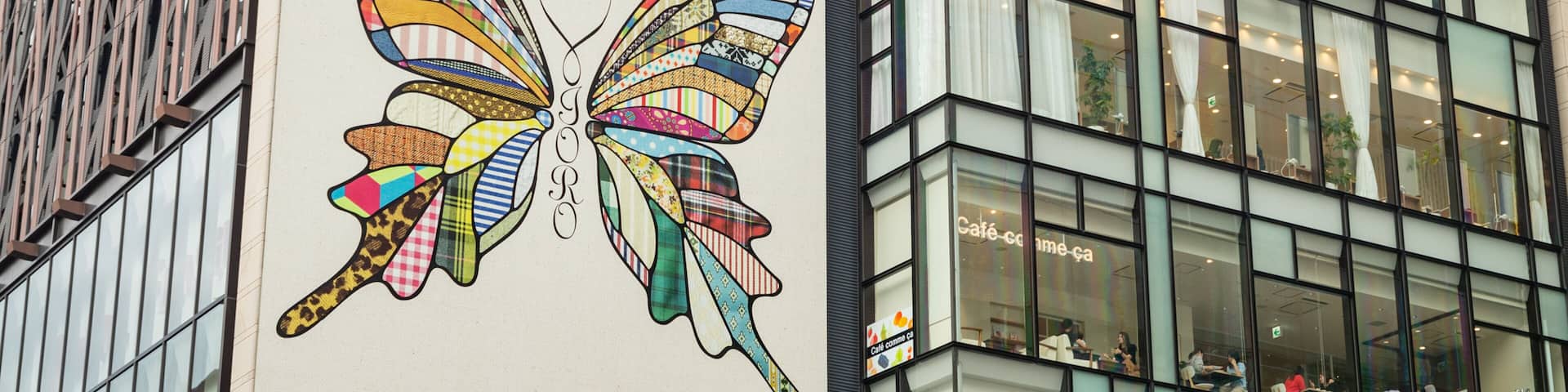 A building with a colorful butterfly mural on its side.