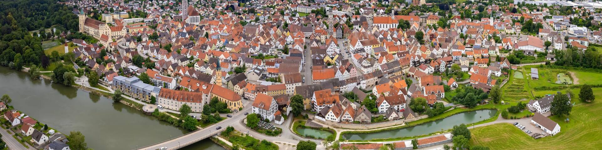 An aerial panorama view above the old town of the city Lauingen on a cloudy summer day in Bavaria, Germany