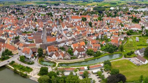 An aerial panorama view above the old town of the city Lauingen on a cloudy summer day in Bavaria, Germany
