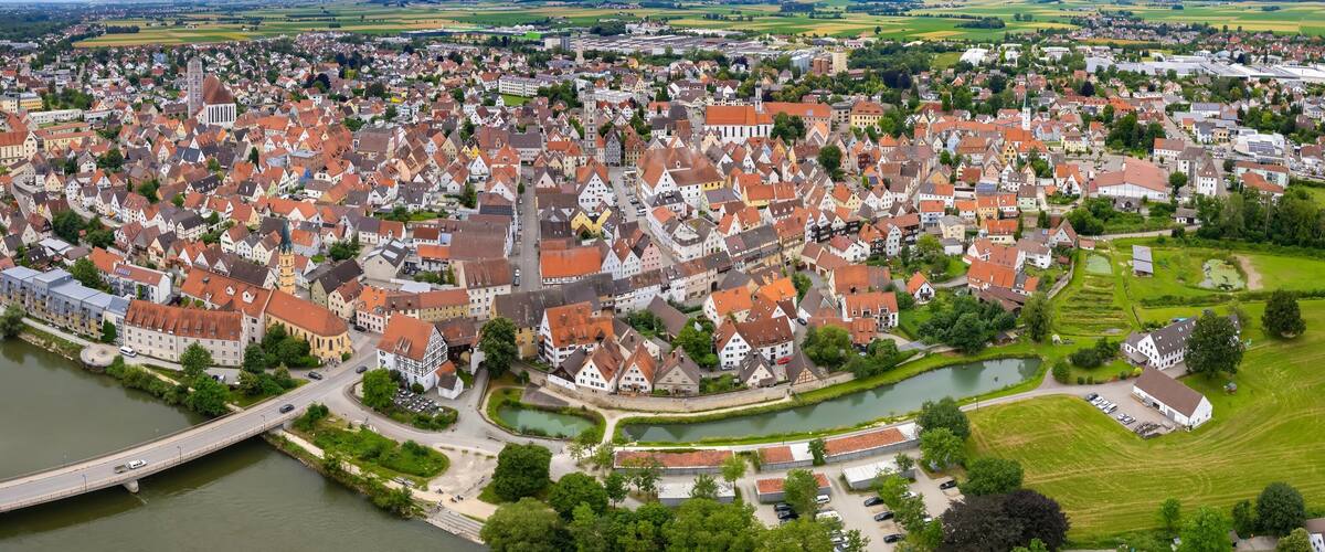 A town with a river, historic buildings, and a bridge.