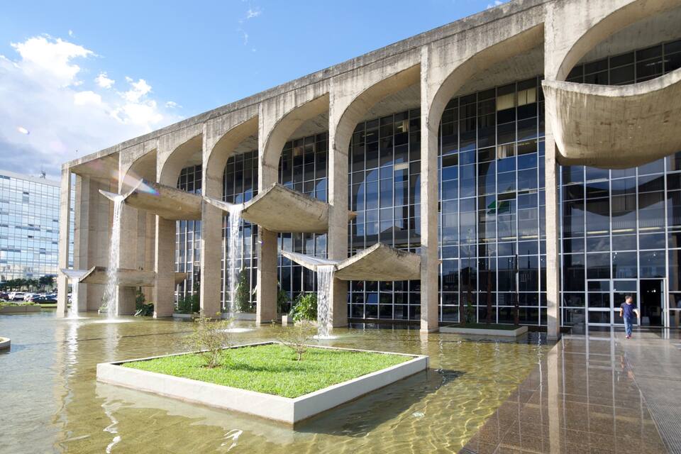 A modern building with large windows and a central water feature.