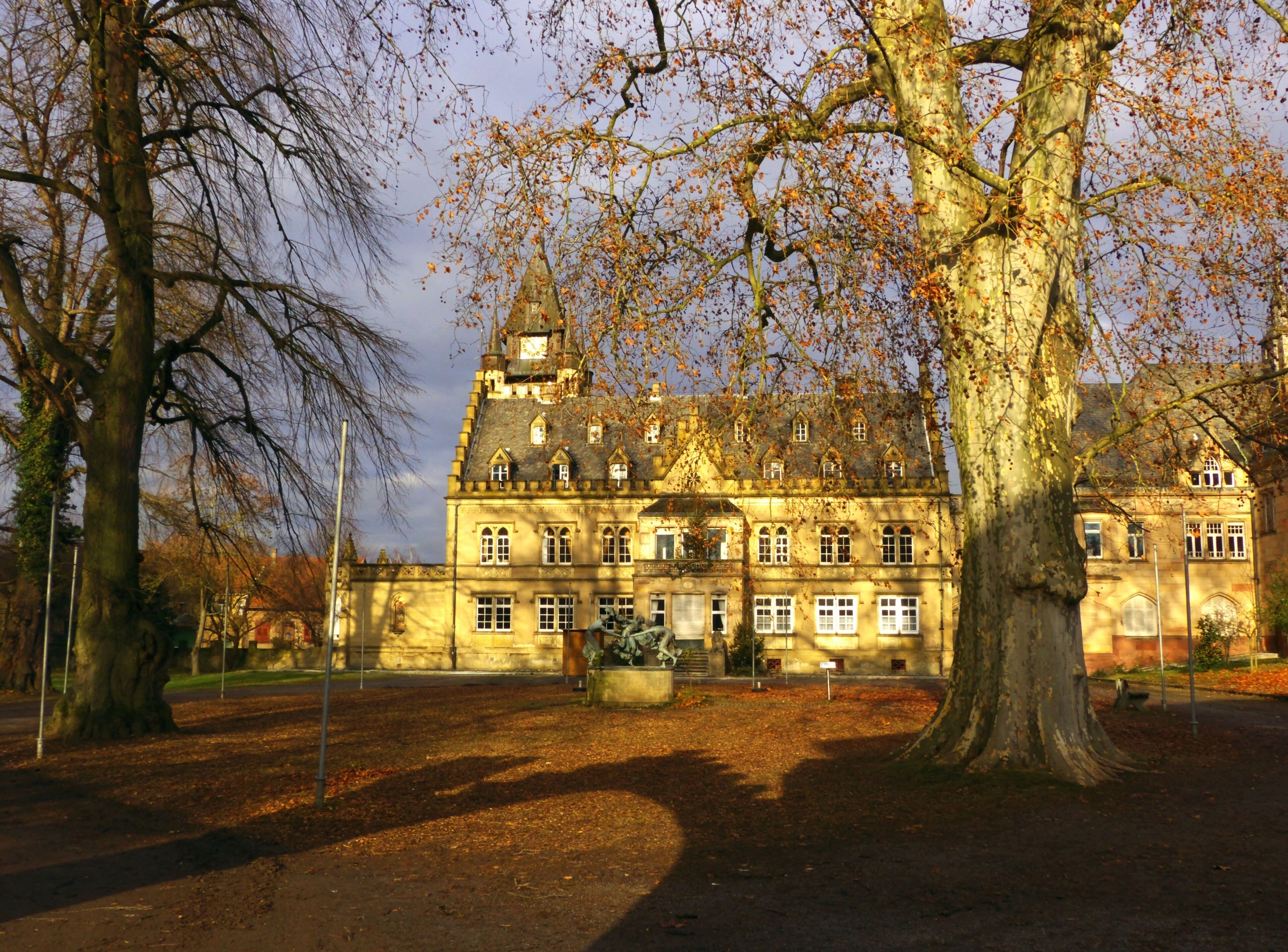 A large historic building with a prominent tower and multiple windows.