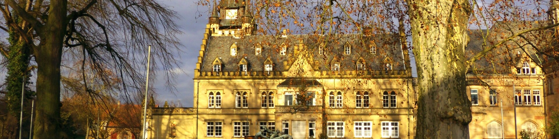 A large historic building with a prominent tower and multiple windows.